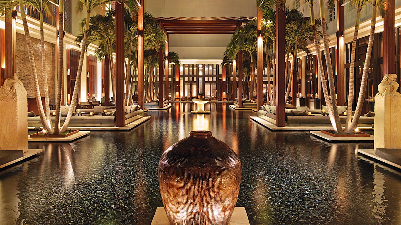 A pool of water, above which is a wood lattice, at Miami Beach’s JAYA at the Setai
